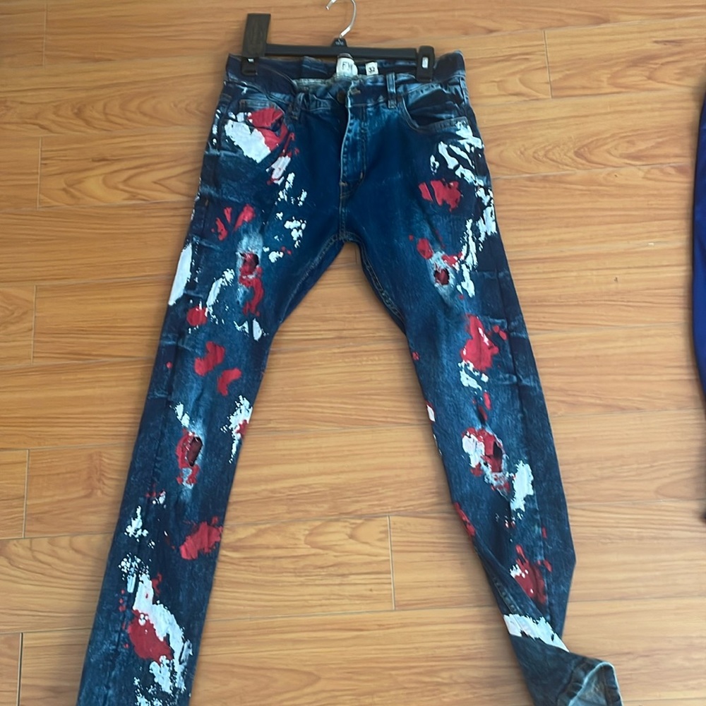 FWRD Denim stretched dark blue jeans with red and white paint splatter